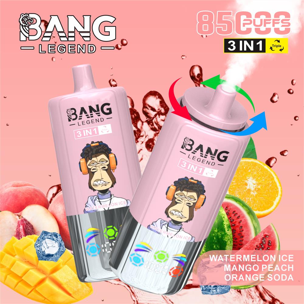 Two pink Bang Legend 3‑in‑1 disposable vape devices featuring a cartoon monkey with headphones and vapour, surrounded by watermelon, mango, peach, orange slices and ice cubes with '8500 puffs' and flavour labels, set against a pink splash background.
