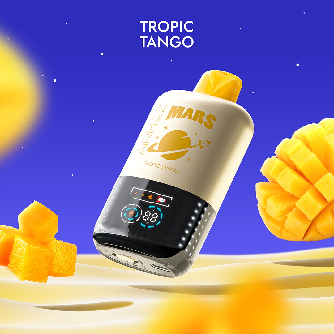 Floating cream-and-yellow bottle labelled MARS Tropic Tango with a yellow cap and a glossy black digital display, hovering over creamy sand dunes against a deep blue starry background with diced and sliced mango pieces nearby.