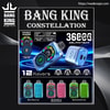 Promotional poster for the Bang King Constellation disposable vape showing metallic blue, pink and green devices with round digital touchscreens and touchable airflow rings, Delphitech branding, and text highlighting 12 flavours and claims of thousands of puffs.