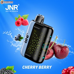 Compact black-and-silver JNR vape device with a glowing circuit-pattern panel and clear mouthpiece, set on a bright blue background with splashing water and scattered cherries, raspberries, blueberries and blackberries, plus JNR and WADEVAPE logos and the text CHERRY BERRY.