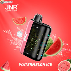 A pink-and-black JNR (Just No Reason) vape device with a patterned black face and clear mouthpiece floats on a bright red background amid splashing ice cubes and watermelon slices, accompanied by the WadeVape logo and the label 'WATERMELON ICE'.