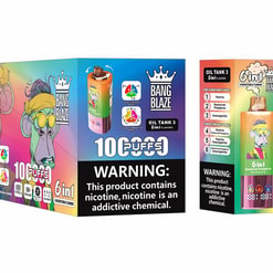 Colourful product shot of Bang Blaze Oil Tank 3 disposable vaping devices and packaging featuring a cartoon monkey graphic, two gradient-coloured vape pens, a box marked '6in1' and '10 PUFFS', and a prominent nicotine warning label.