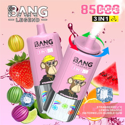 Two pink BANG LEGEND 3‑in‑1 disposable vapes with a cartoon ape wearing a yellow hat, surrounded by strawberries, watermelon, citrus slices, candy-like spheres and ice cubes on a pink background, with graphics advertising a high puff count and fruit-flavour names.