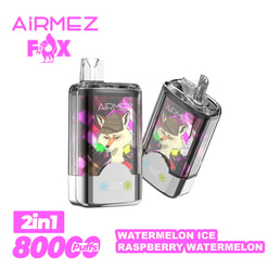 Two transparent AiRMEZ Fox disposable vape devices featuring a stylised fox wearing a beanie on a pink geometric panel and chrome base, shown with pink AiRMEZ Fox branding and labels stating 2in1, 8000 puffs and flavours Watermelon Ice and Raspberry Watermelon.
